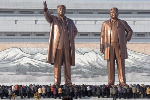 North Koreans bow before the statues of late leaders, Kim Il Sung, left, and Kim Jong Il, at Mansu Hill in Pyongyang, North Korea, Monday, Dec. 17, 2012. Sirens wailed for three minutes at noon Monday in honor of the first anniversary of the death of Kim Jong Il. (AP Photo/Ng Han Guan)